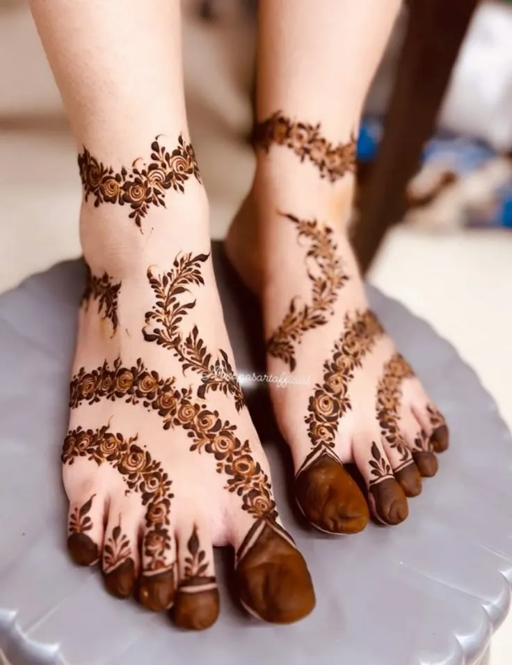 40+ Foot and Leg Mehndi Designs: Easy, Simple & Bridal Look for 2026 25 diagonal bel across the foot and leg mehndi design