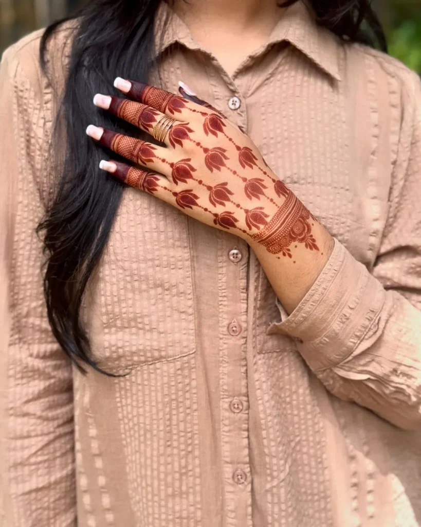 60+ Stylish Back Hand Mehndi Designs You Must Try in 2026! 18 pichwai-inspired back hand mehndi designs