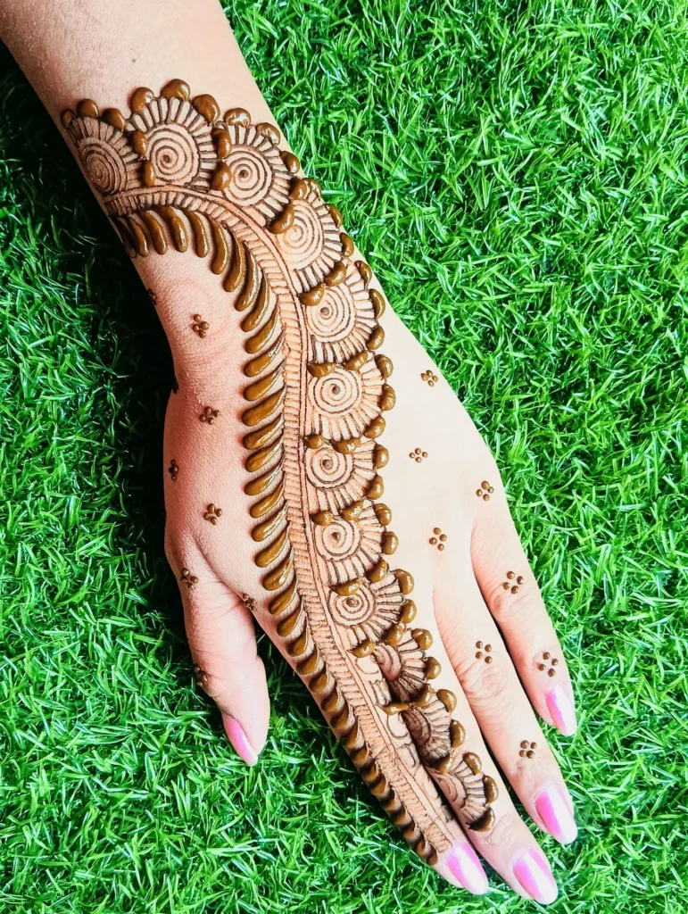 60+ Stylish Back Hand Mehndi Designs You Must Try in 2026! 28 spiral back hand mehndi designs