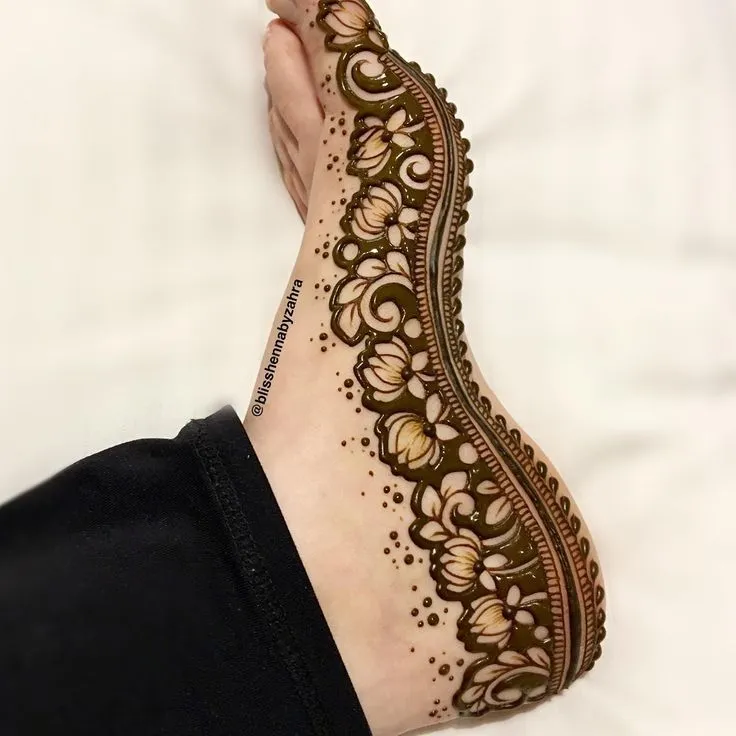 40+ Foot and Leg Mehndi Designs: Easy, Simple & Bridal Look for 2026 34 trail with dots side foot and leg mehndi designs
